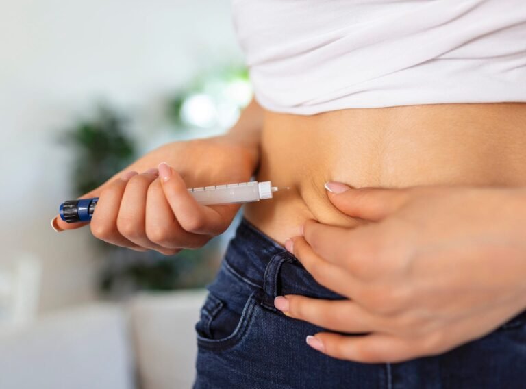 A diabetic patient using insulin pen for making an insulin injection at home. Young woman control diabetes. Diabetic lifestyle